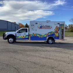 Photo of Logan County Paramedics new delivery showcasing the exterior of the vehicle and it's features.