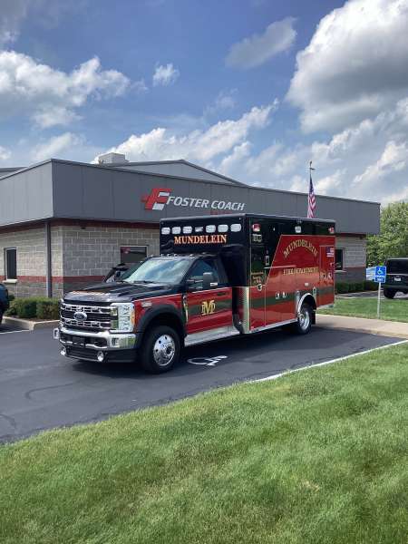 Photo of New Delivery Mundelein Fire Department outside of Foster Coach building.