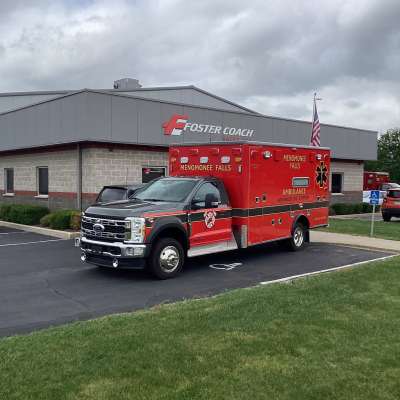 New Delivery Menomonee Falls Ambulance outside of the foster coach building.