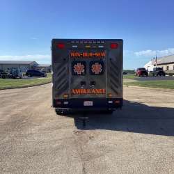 Photo of New Delivery Win Bur Sew Fire Protection Dist. ambulance outside.