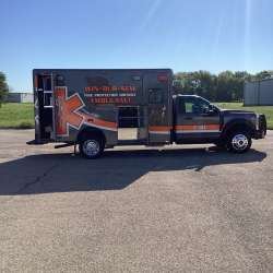 Photo of New Delivery Win Bur Sew Fire Protection Dist. ambulance outside.