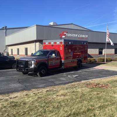 New Delivery City of Pewaukeee Ambulance outside of the foster coach building.