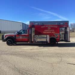 Photo of City of Pewaukee Paramedic Unit ambulance parked outdoors.
