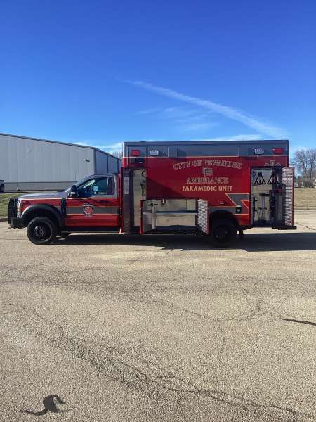 Photo of City of Pewaukee Paramedic Unit ambulance parked outdoors.