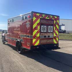 Photo of City of Pewaukee Paramedic Unit ambulance parked outdoors.