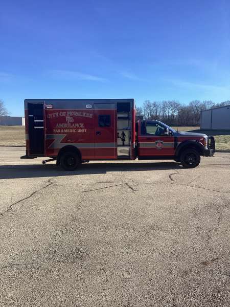 Photo of City of Pewaukee Paramedic Unit ambulance parked outdoors.