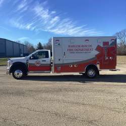 Photo of Roscoe Fire Department ambulance vehicle being showcased outside.