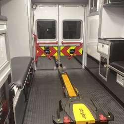 Photo of Roscoe Fire Department ambulance vehicle showing the interior with available equipment and hardware.