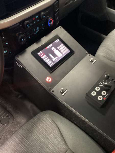 Photo of Interior view of an ambulance driver’s cab showing the center control console.