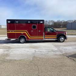 Photo of Troy Fire Department ambulance parked outdoors showcasing the vehicle.